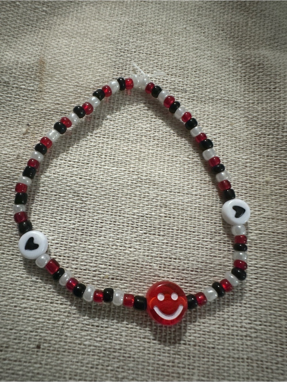 Handmade Beaded Bracelet with Red Smiley Charm